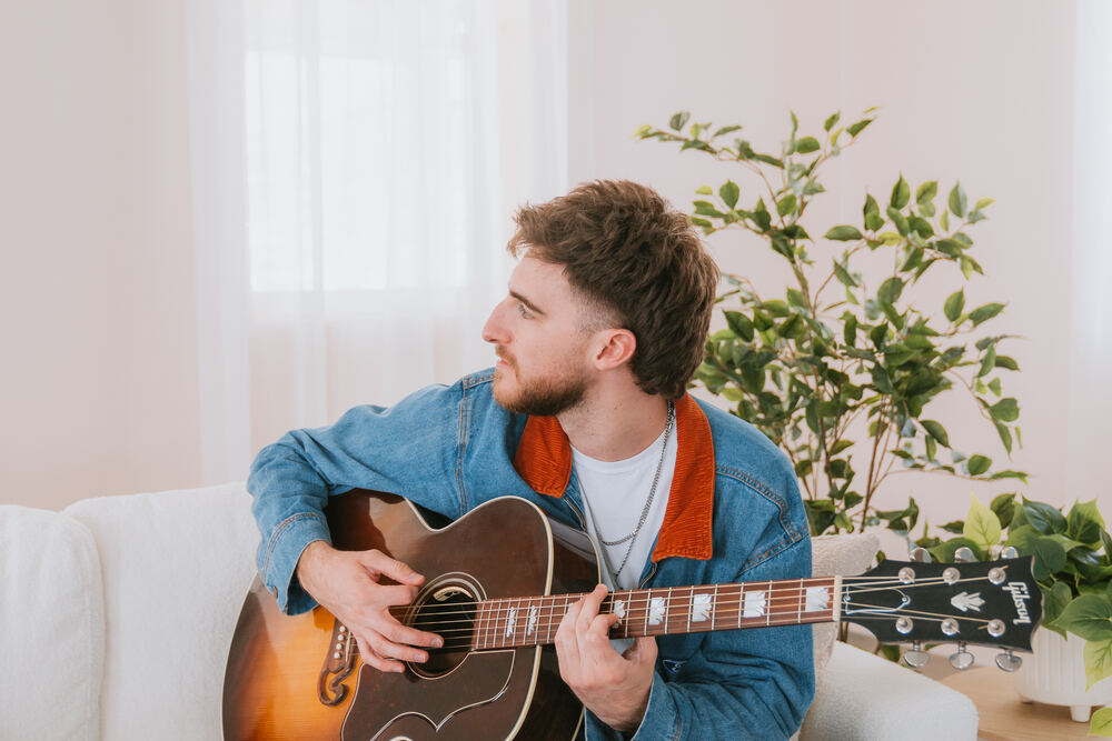 Chandler Letner color portrait playing guitar