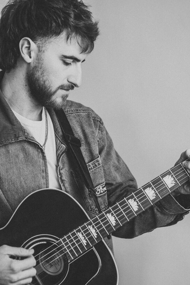 Chandler Letner black and white portrait with guitar