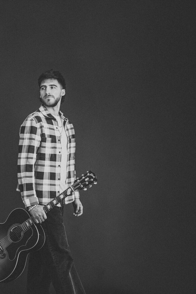 Chandler Letner black and white full length portrait with guitar